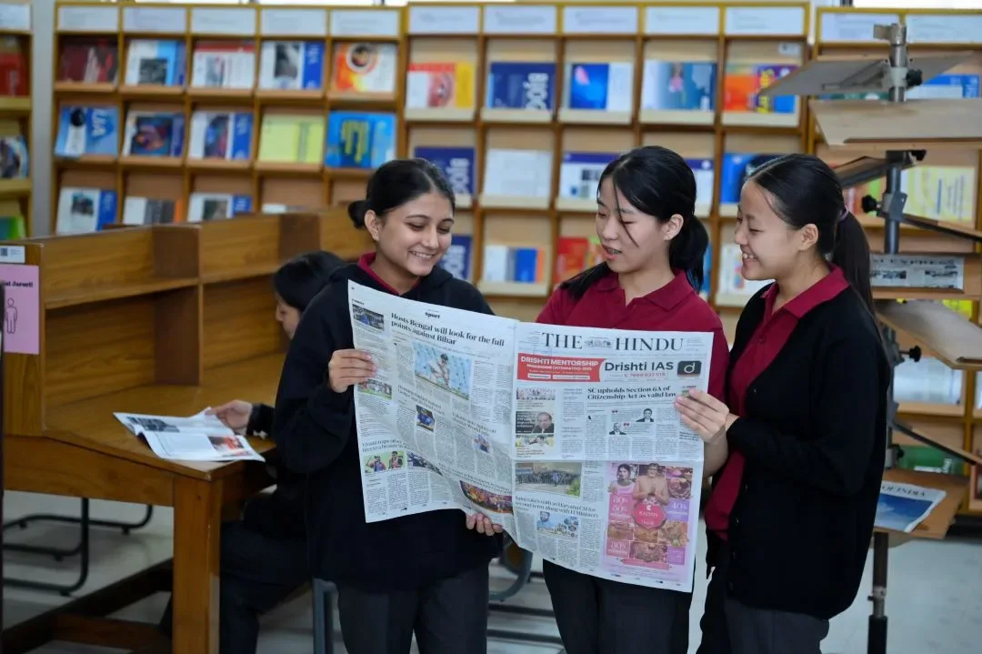 Students reading beside bookshelves in the college library — Sikkim Manipal College of Nursing