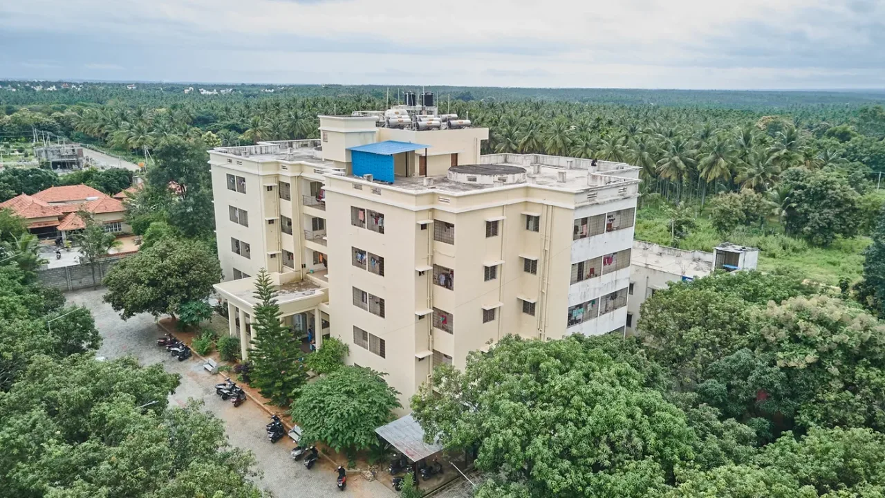 Aerial drone view of a hostel block at Shridevi Institute of Medical Sciences Tumkur amid coconut groves
