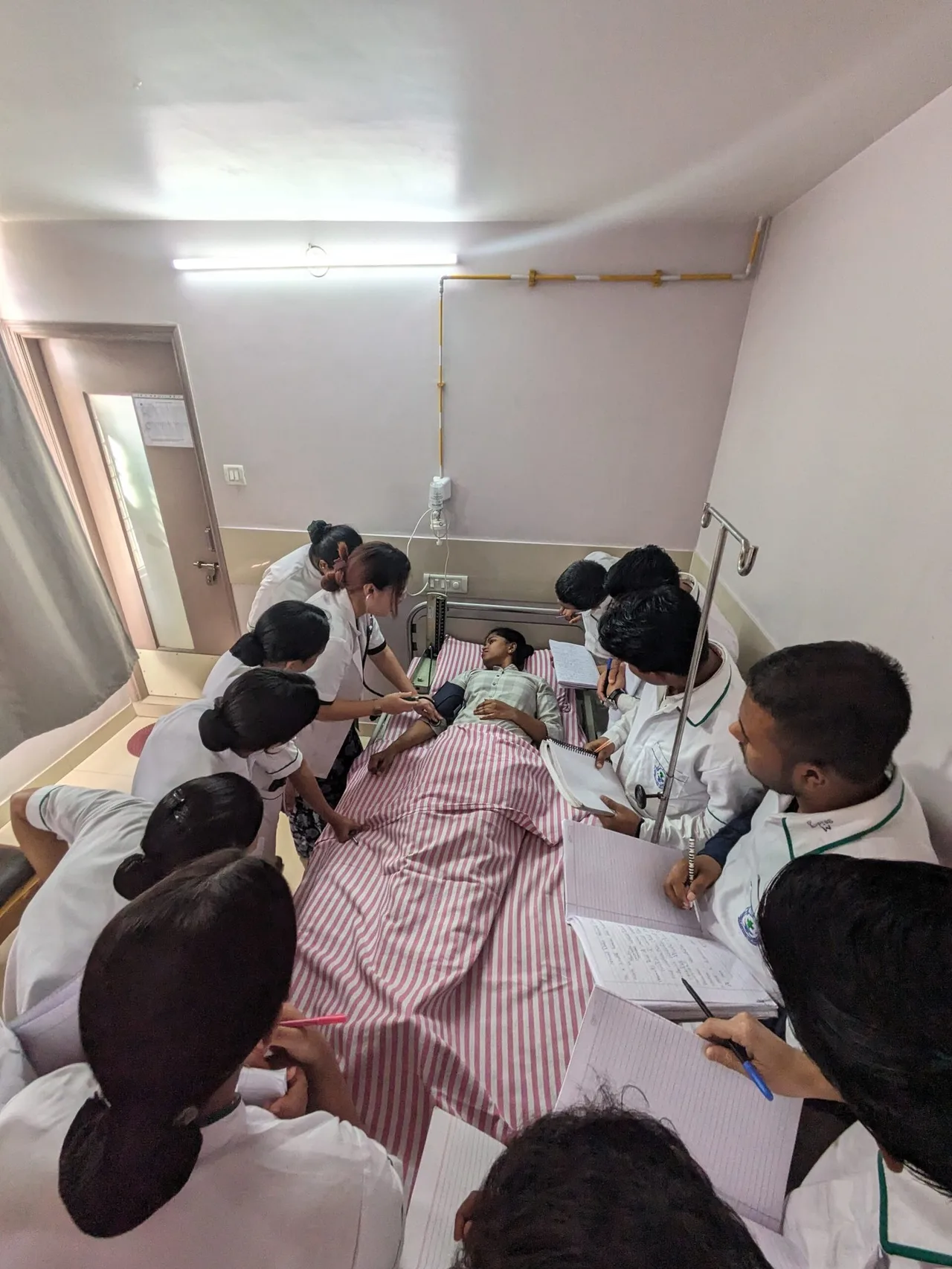 Anupama School of Nursing — Homepage Embedded Image Labelled Pxl Clinical Practice Scene With Students At Bedside