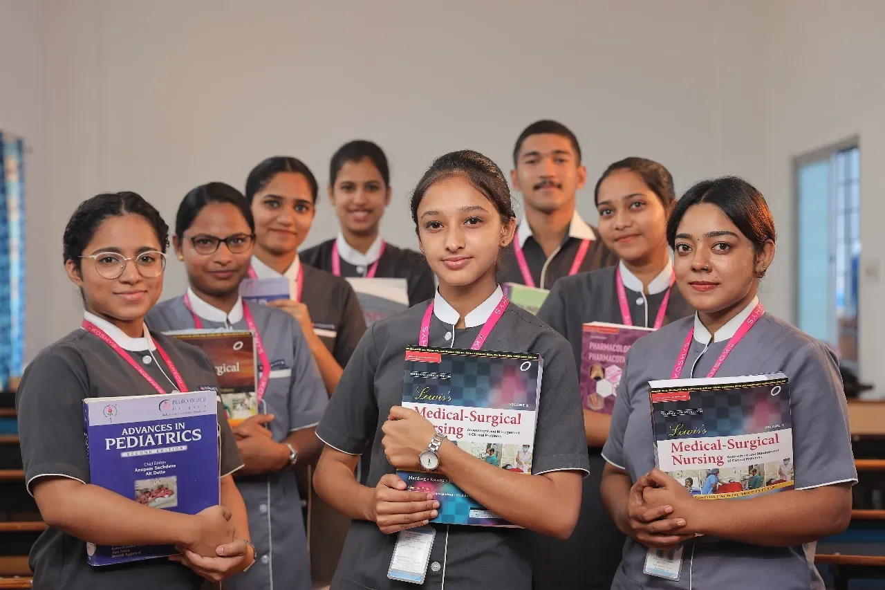 Group of uniformed nursing students with textbooks — Bangalore Little Flower College of Nursing
