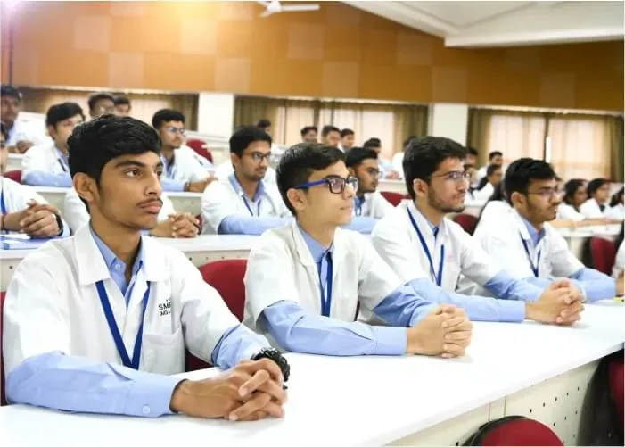 MBBS students in white coats seated in a lecture hall at SMBT Institute of Medical Sciences, Nandi Hills