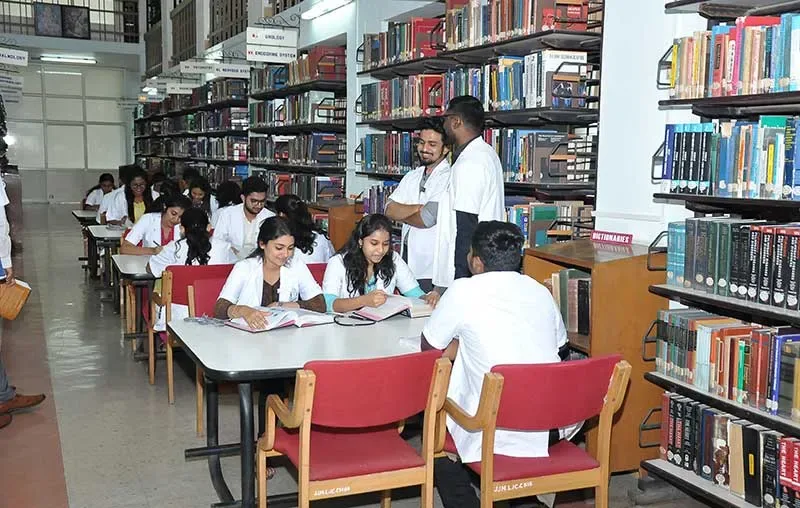 MBBS students in white coats studying in the central library of JJM Medical College Davangere