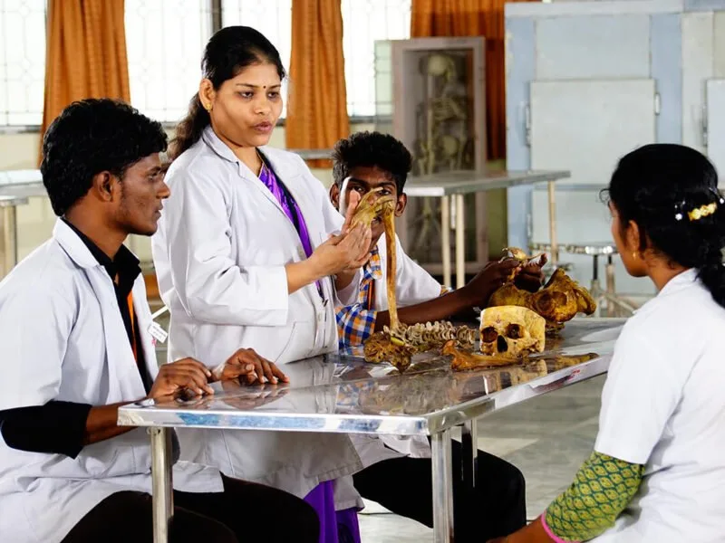An Anatomy demonstrator teaching MBBS students with bone specimens at ACS Medical College and Hospital, Chennai
