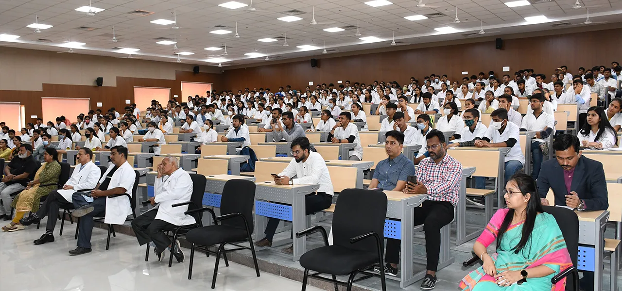 MBBS students in white coats filling a large lecture theatre at Banas Medical College & Research Institute, Palanpur