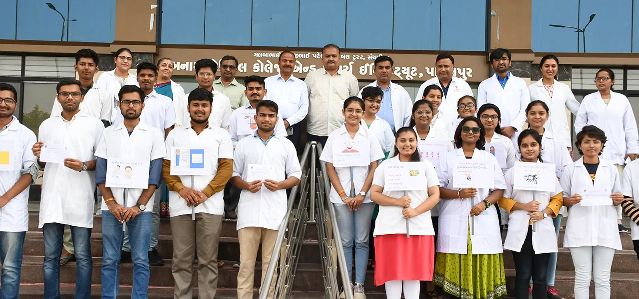 Banas Medical College & Research Institute MBBS students in white coats on the college steps below the college name banner