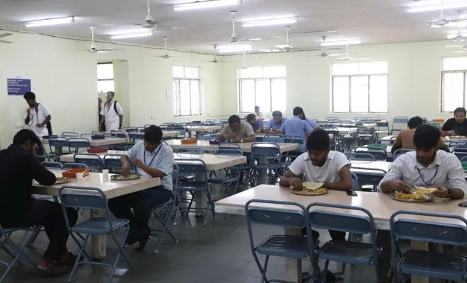 Students dining in the hostel mess hall at Chettinad Hospital and Research Institute, Kelambakkam