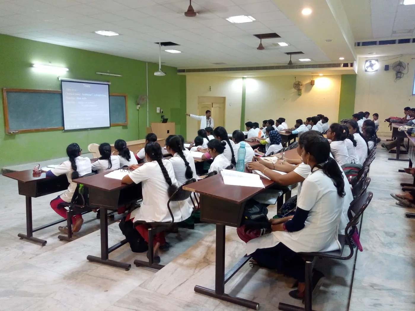 MBBS students in white coats in a teaching hall at Karpaga Vinayaga Institute of Medical Sciences