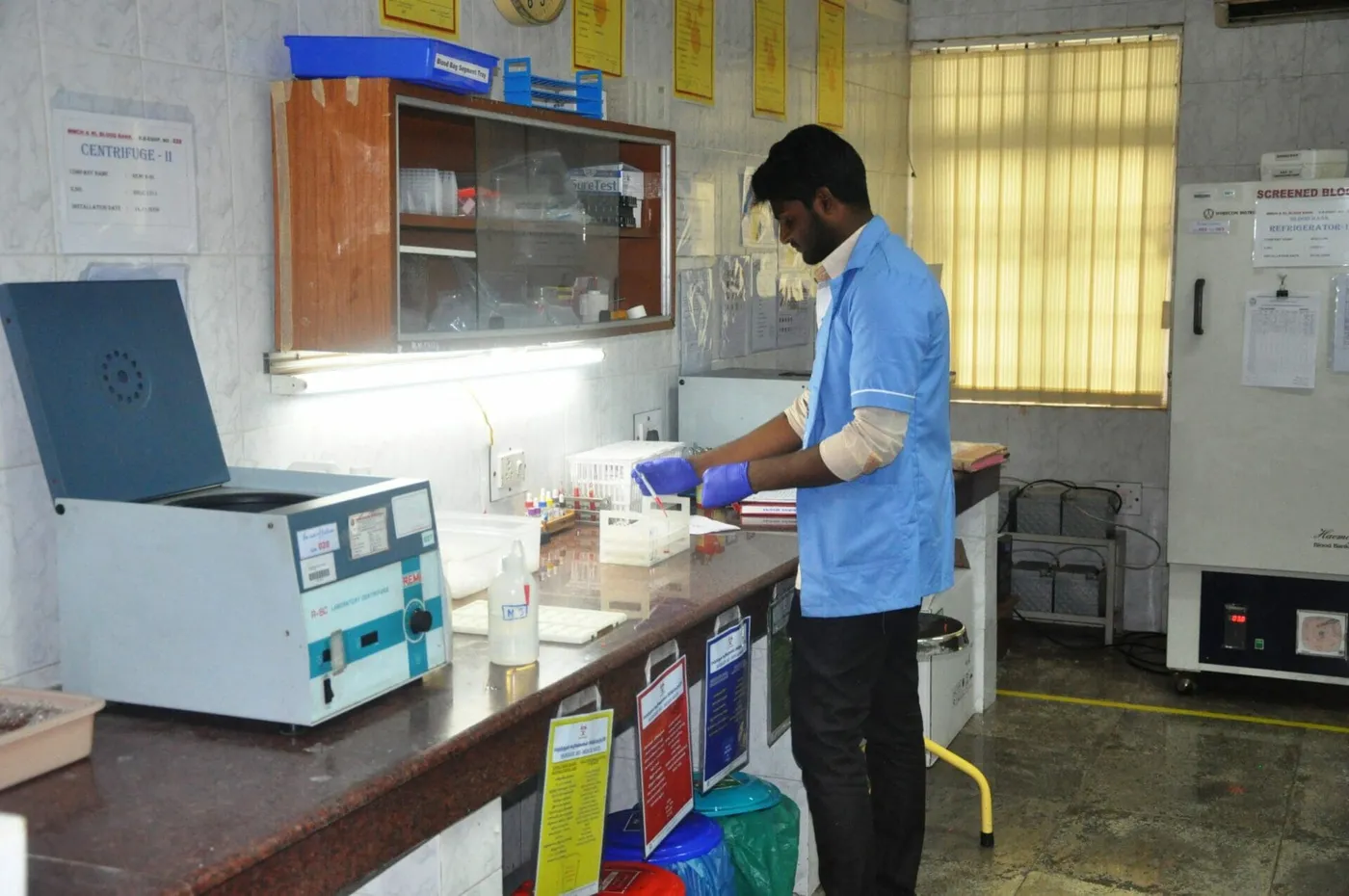 Laboratory technician at the centrifuge in the blood bank of Meenakshi Medical College Hospital, Kanchipuram