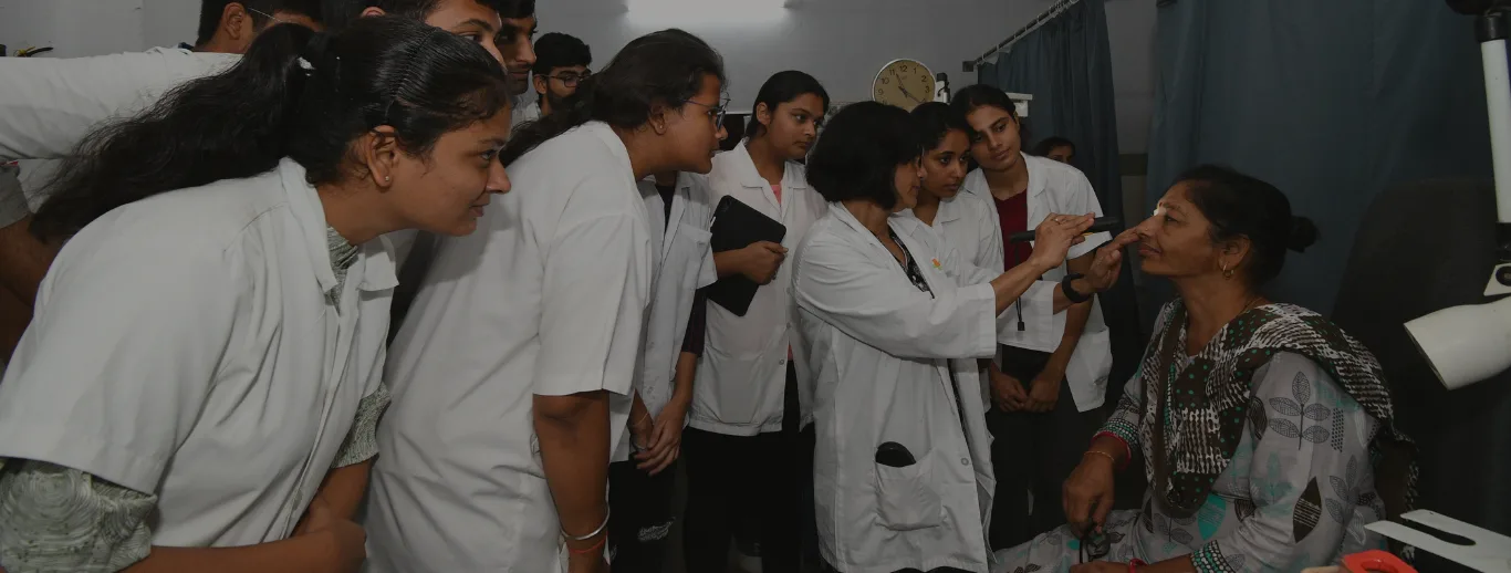 Pramukhswami Medical College students practising clinical examination skills on each other in a skills session