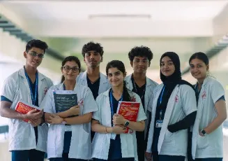 A group of MBBS students in white coats on campus at Sri Ramachandra Medical College, Chennai