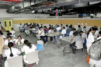 Students dining in the campus cafeteria at The Oxford Medical College, Bangalore