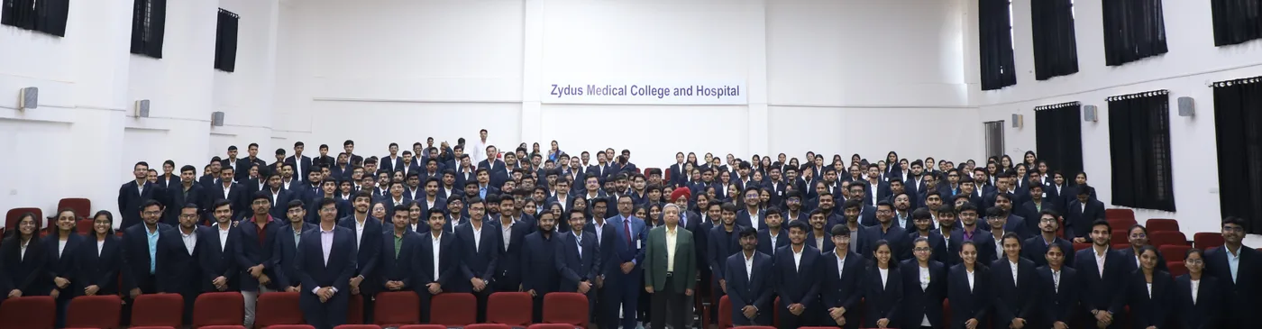 Zydus Medical College and Hospital students assembled in the college auditorium beneath the institution's name board