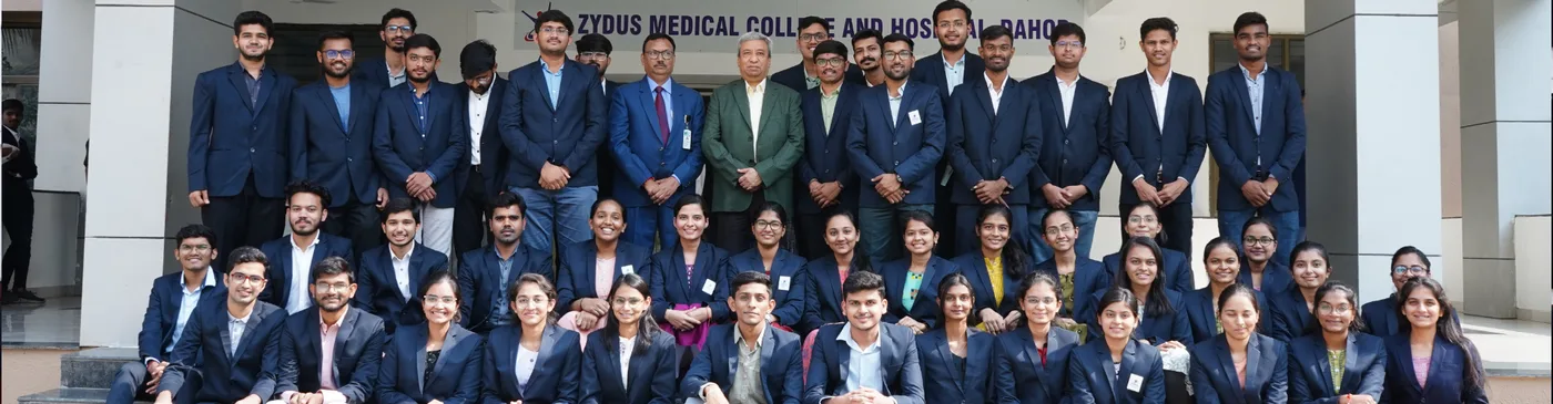 Zydus Medical College and Hospital students with senior faculty outside the main entrance at Dahod